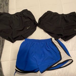 Three pairs of Nike running shorts